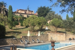 View of the swimming pool with the B&B on the hill behind it